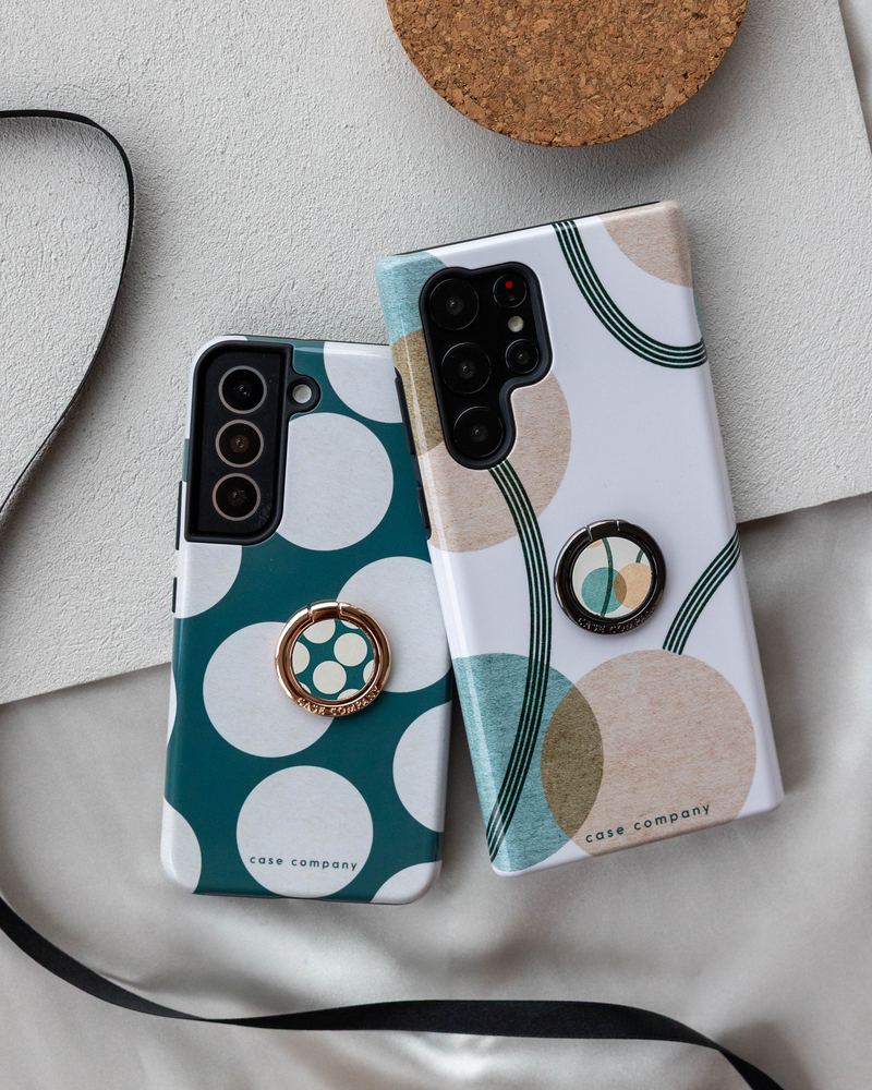 Gold and black ring holders on cases with dots and circles